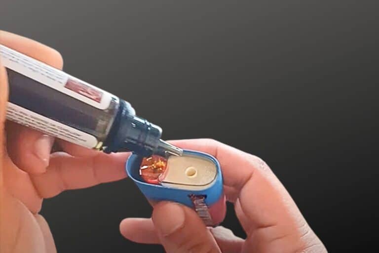 A guy refilling elf bar bc 5000 with vape juice for more use