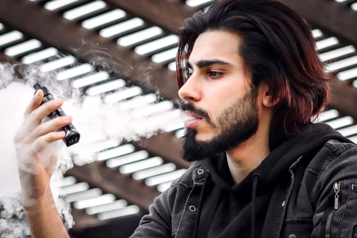 A guy vaping and thinking is it safe after removal of his wisdom tooth.