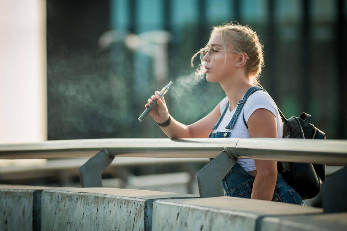A lady vaping before going to airport.