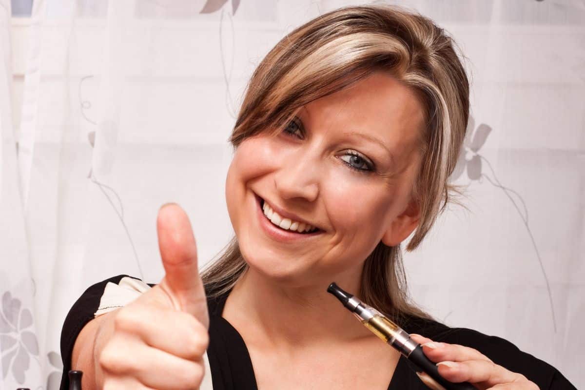 Woman giving a thumbs up while holding one of the healthiest vapes.