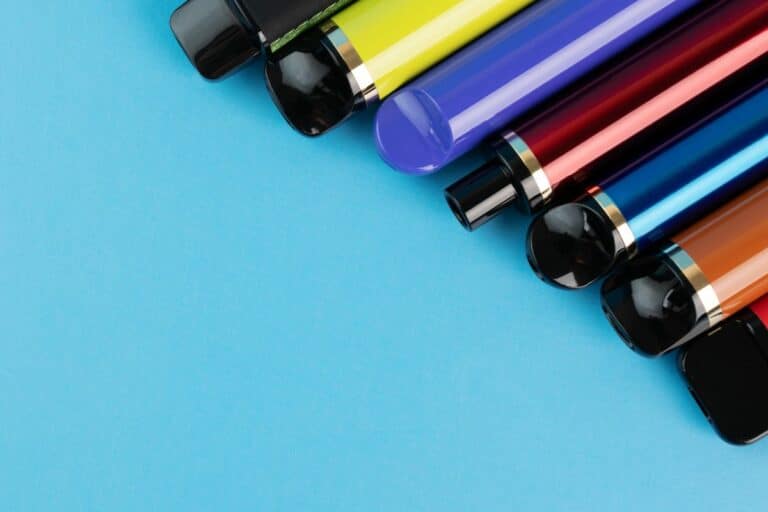 A collection of popular disposable vape brands arranged diagonally on a blue background.