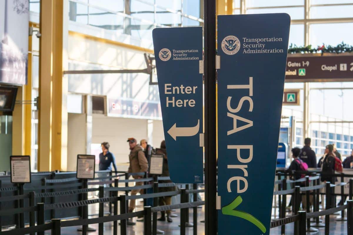 Signage indicating how to get vape juice out of clothes at an airport security checkpoint.