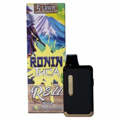 A 5-gram packaged product labeled "Ronin Disposable Vapes 5g" with a mountain image, alongside a black vaping device with gold accents. The text "RS11 Indica" is visible on the packaging, showcasing the sleek design of Ronin Disposable Vapes.