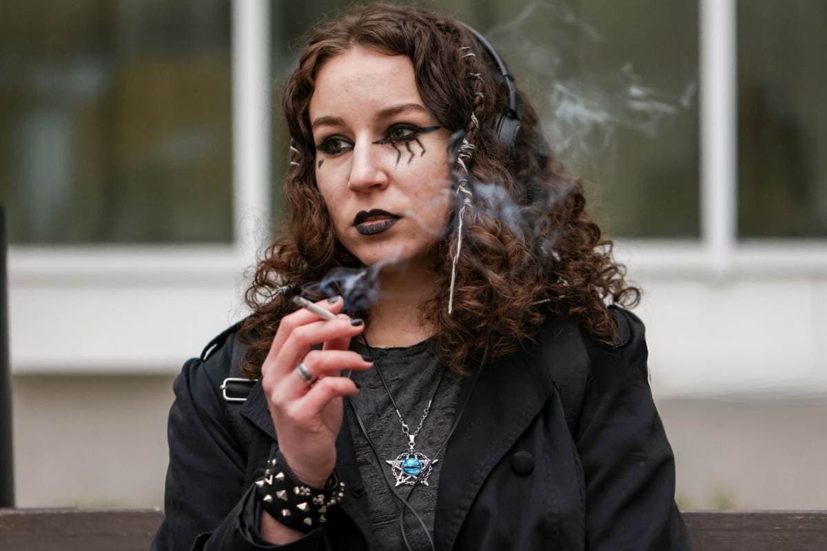 A lady is in anime cosplay smoking weed