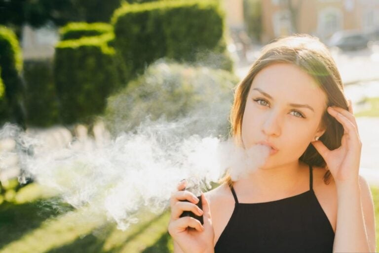 A lady is vaping outside in Denton, Texas
