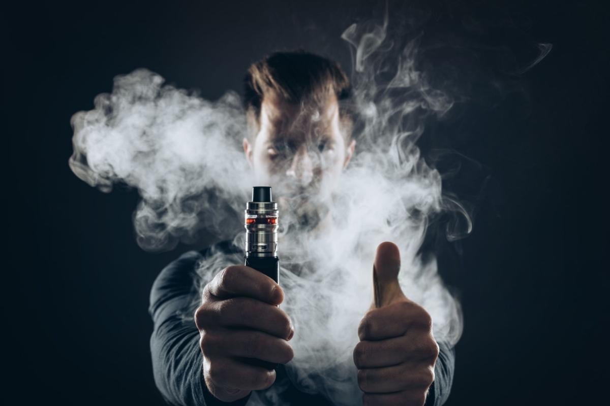 A person is using delta 8 brand vape