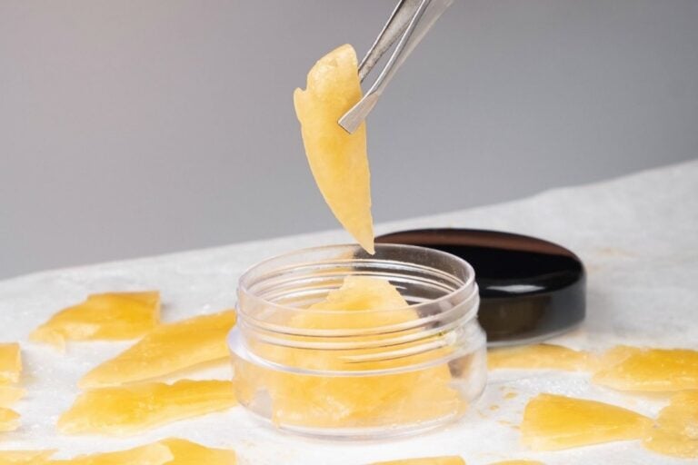 A person taking out 1 gram of cannabis concentrate for dabbing