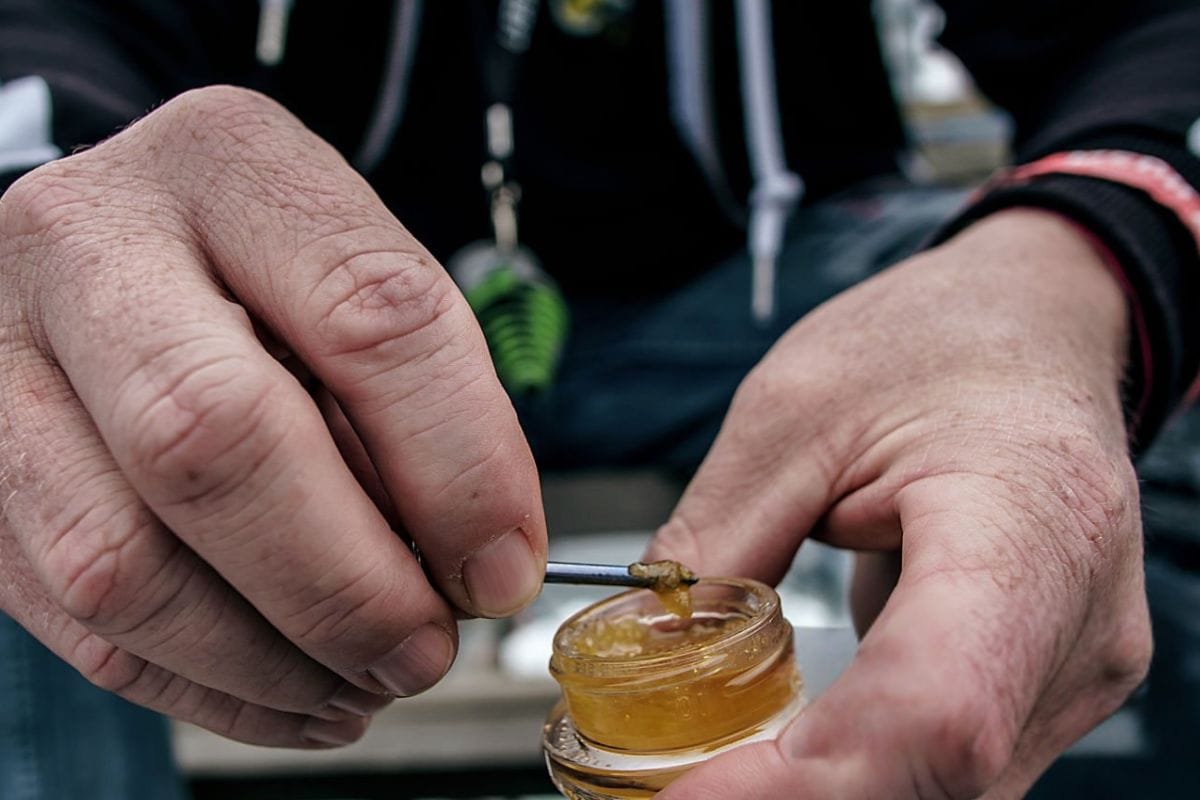 A person is preparing to dab cannabis concentrate