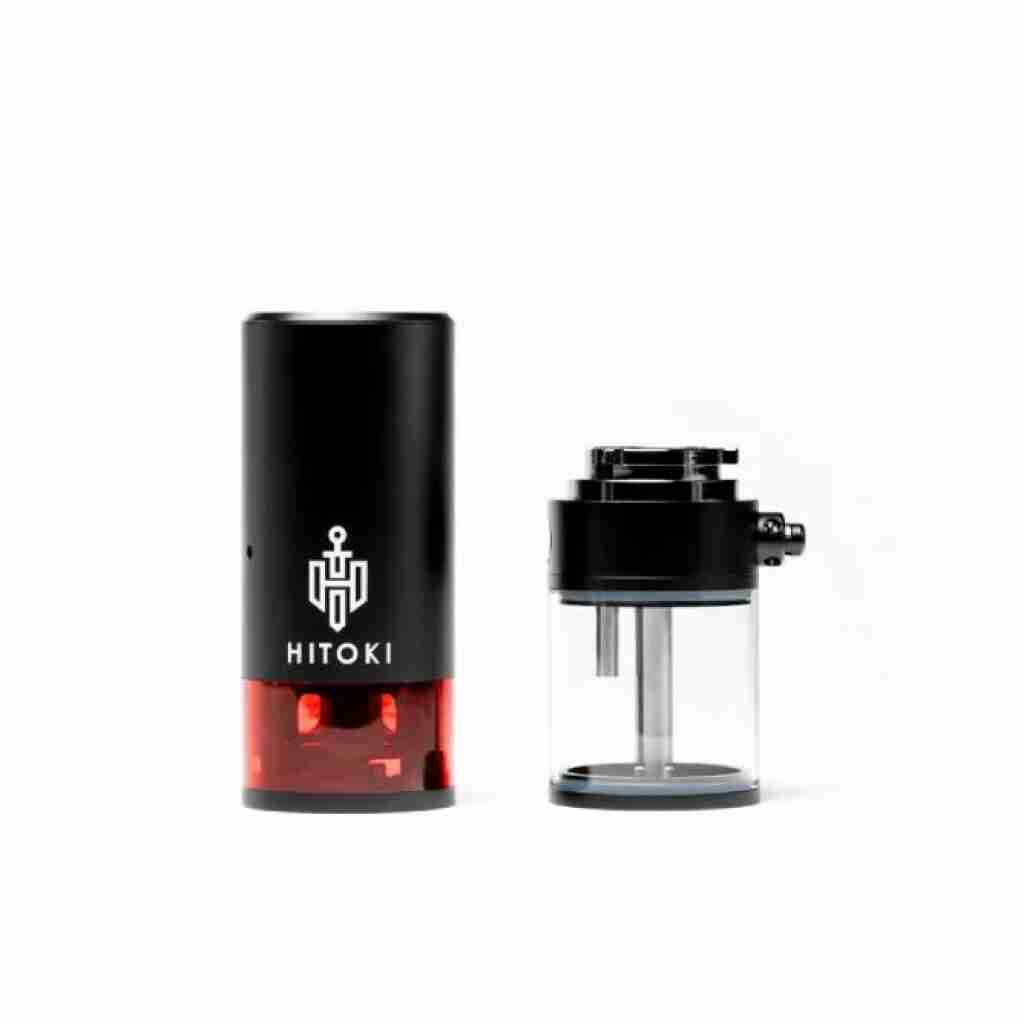 The Hitoki Trident Laser Smoking Device - Black is a sleek, modern black and red device featuring a cylindrical component with the iconic Hitoki logo and a detachable glass chamber with metal interior, perfect for those who appreciate innovative elegance.