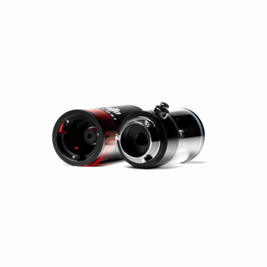 Two metallic cylinders with a glossy finish rest on a white background. One is the Hitoki Trident Laser Smoking Device, black with red accents, while the other is silver and black; both have black connectors on top, indicating they are electronic components or connectors.
