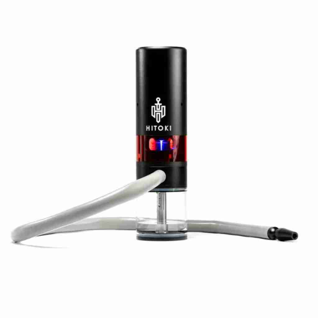 The Hitoki Trident Laser Smoking Device in black features a transparent base and flexible gray hose with the Hitoki brand displayed. It emits a gleam of blue light inside, showcasing its sleek design in black and red.