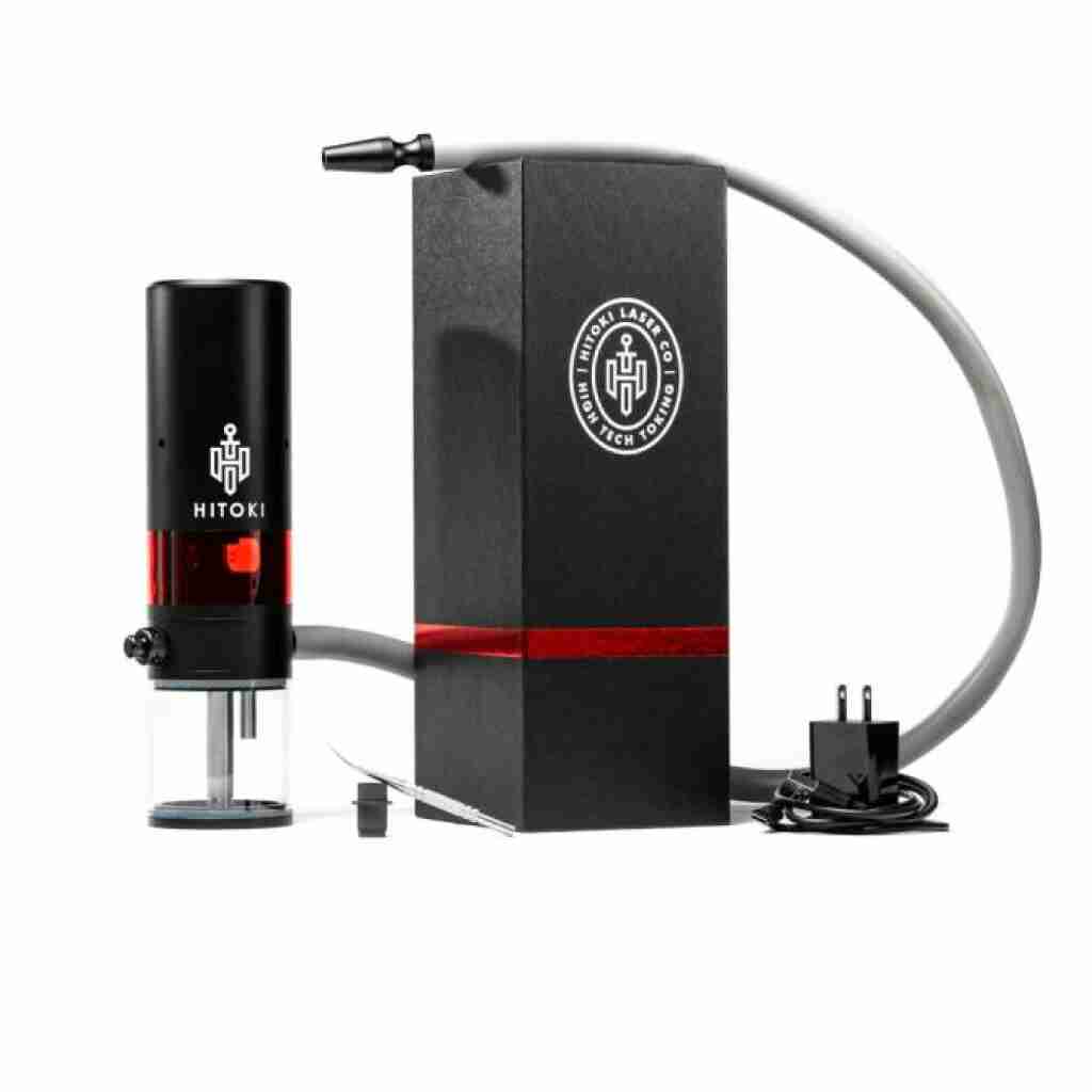Image of a Hitoki Trident Laser Smoking Device in black, featuring a red stripe, placed beside a branded box containing the power adapter, gray hose, and other accessories. This sophisticated setup is elegantly displayed on a white background.