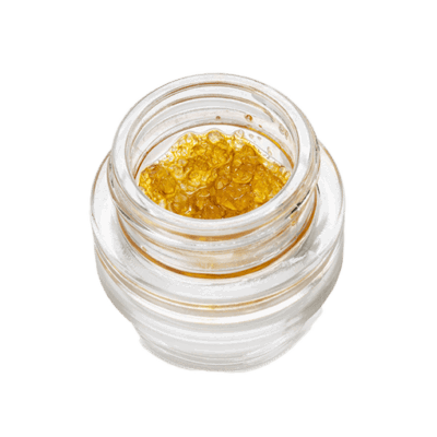A small glass jar filled with golden, translucent gel-like concentrate. The substance appears smooth and slightly viscous, filling the jar nearly to the brim. The jar is clear and round, allowing the contents to be clearly visible.