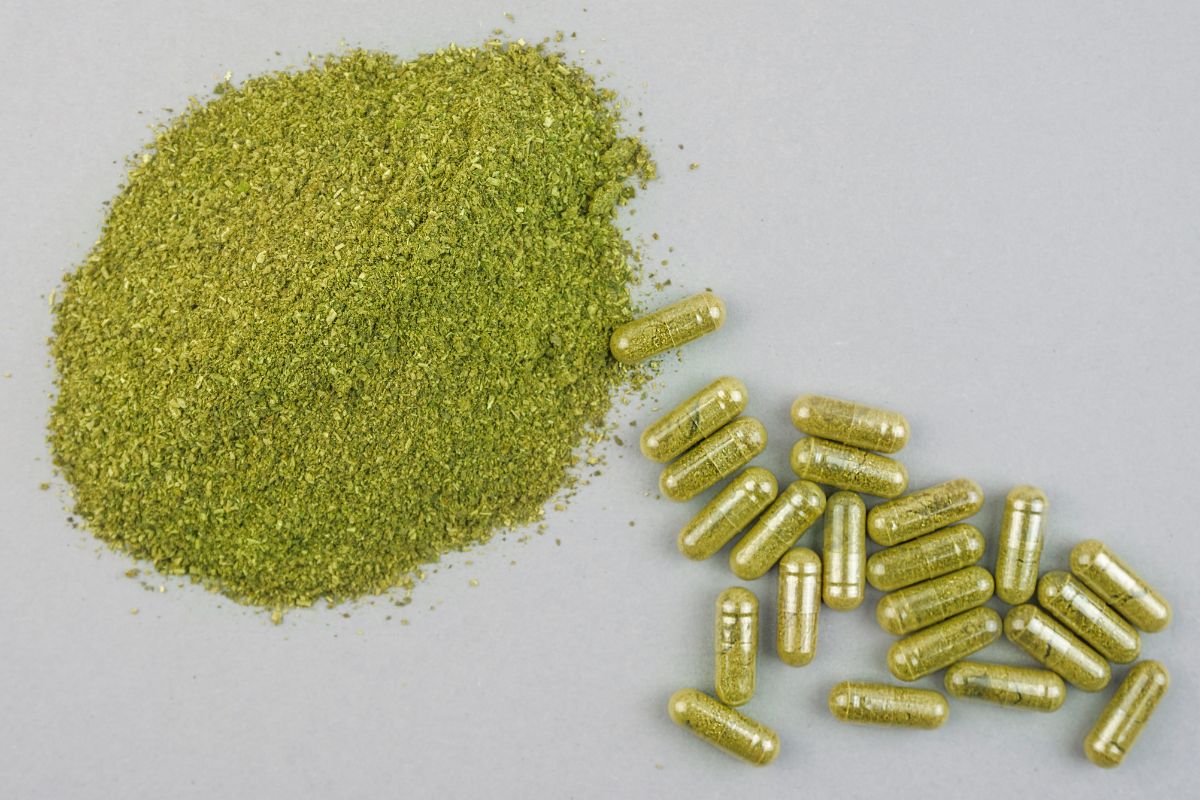 Kratom capsules and powder kept with each other