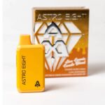 Yellow Astro Eight vape device in front of its packaging, which is orange with white text and a geometric design. The packaging has Astro Eight and a space-themed logo. The device is small and rectangular.