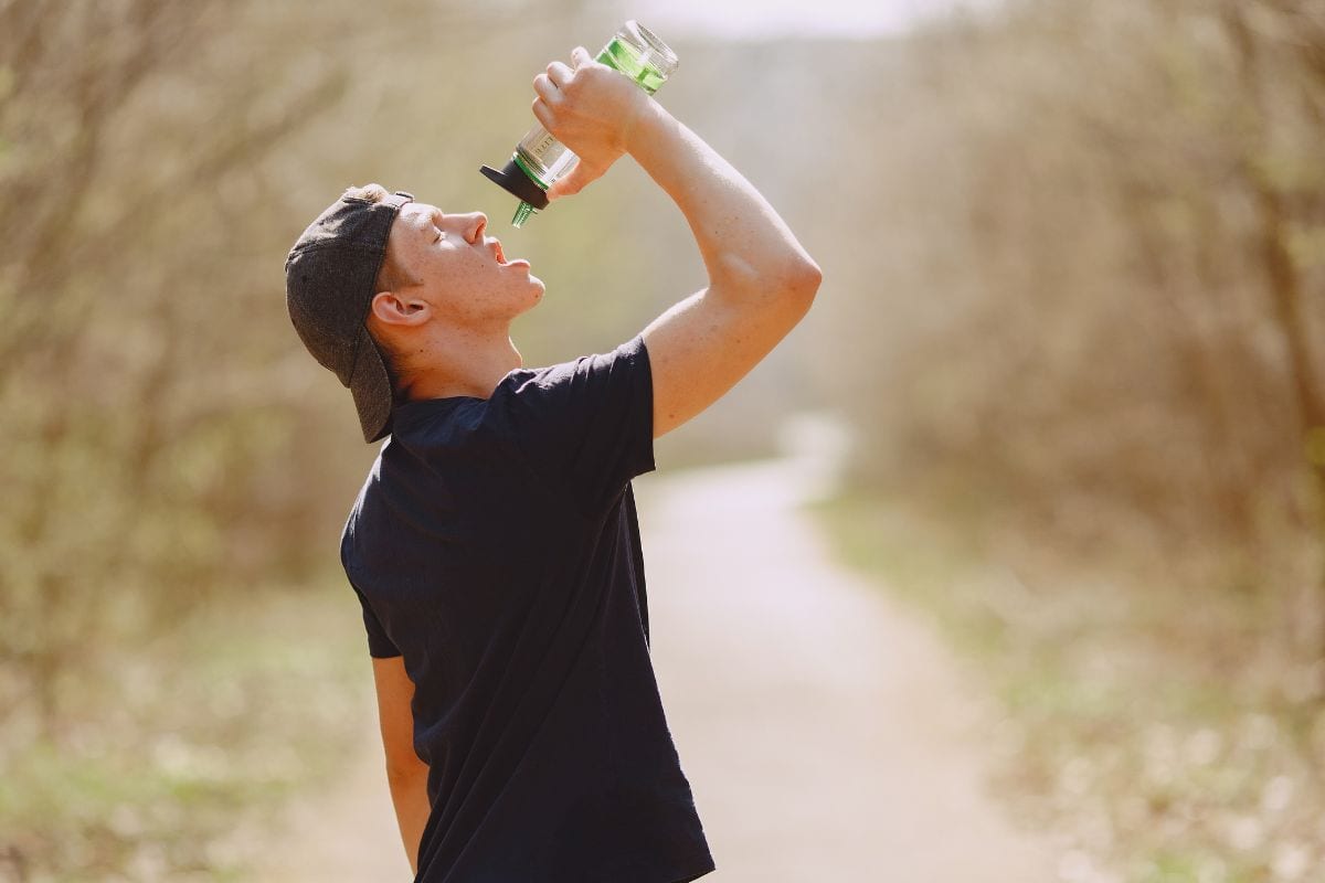A person drinking water and doing exercise to flush out thca and other cart's cannabinoids from the body