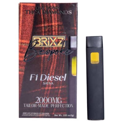 A THCA Disposable sits by its packaging, which features a plaid design with BRIXZ NYC Bespoke THCA Disposable 2g and 2000MG Tailor-Made Perfection. The device includes a small transparent window for convenience.