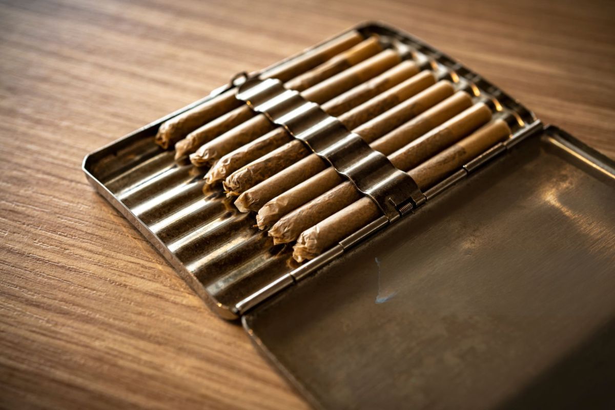 A box containing a collection of rolled joint papers for proper storage and care