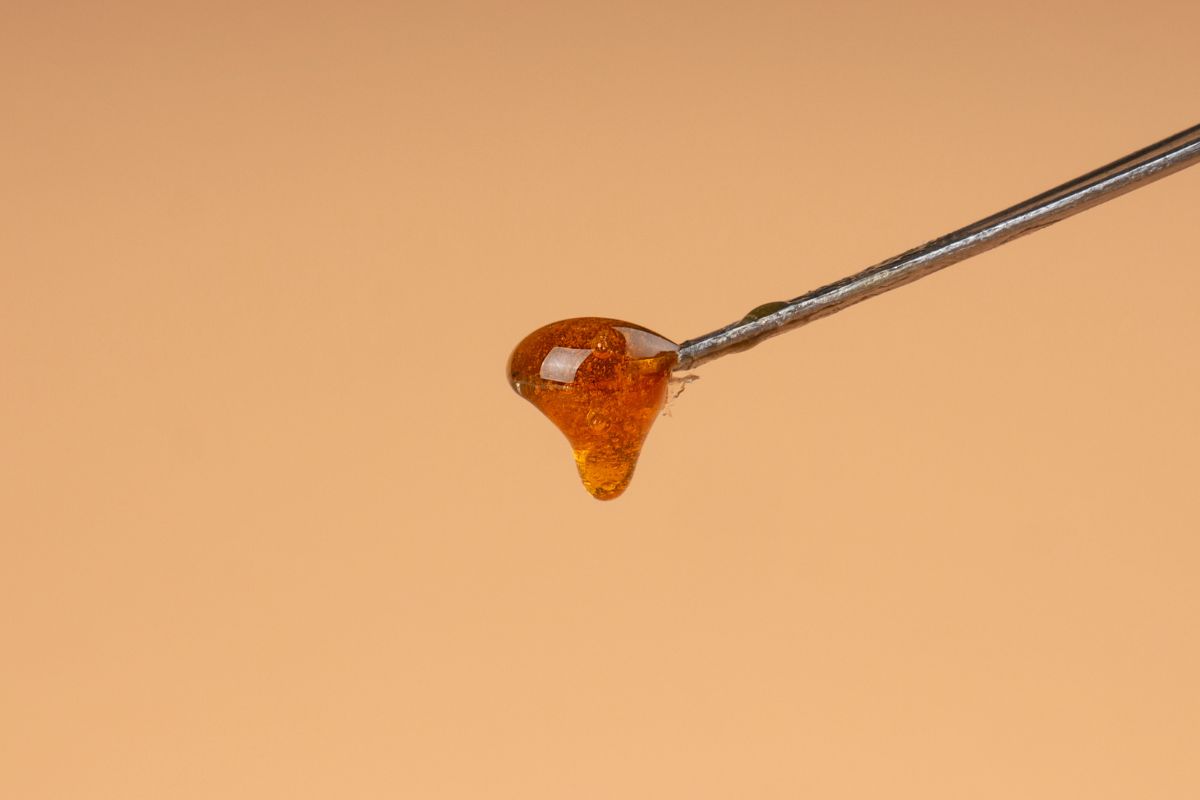 A person collecting dab reclaim using a reclaim catcher