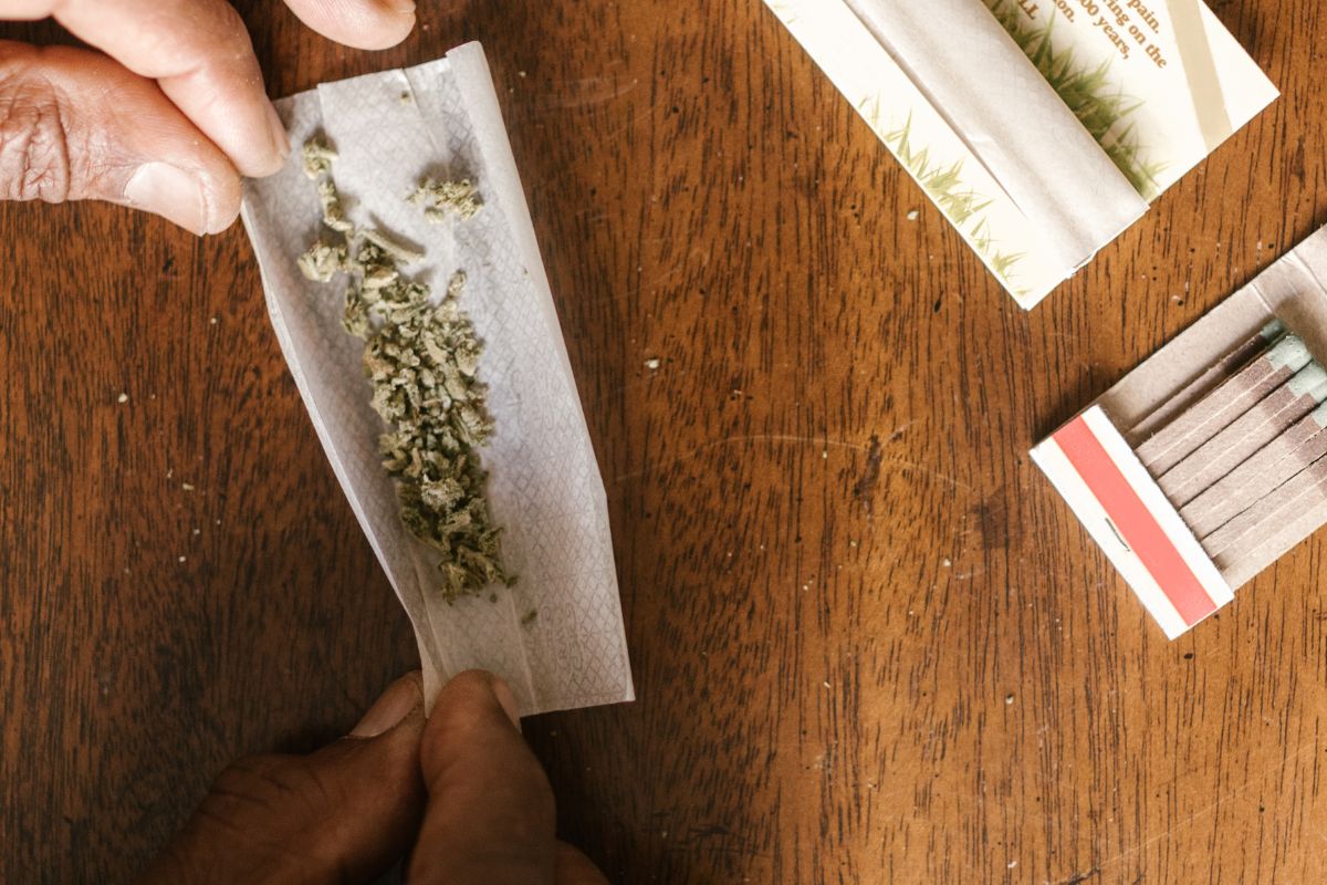 A person preparing a rolling paper with hands