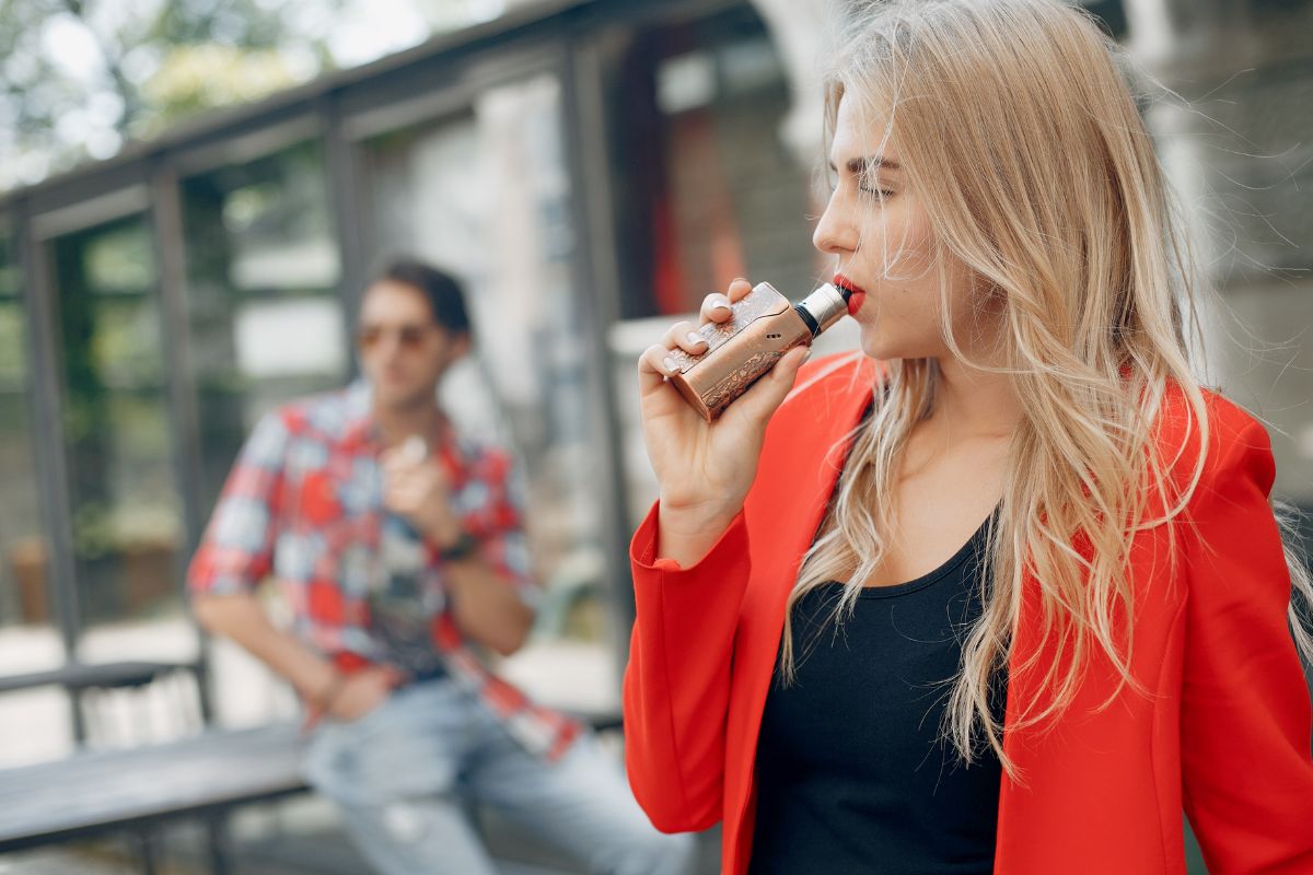 Two friends vaping near a gas station