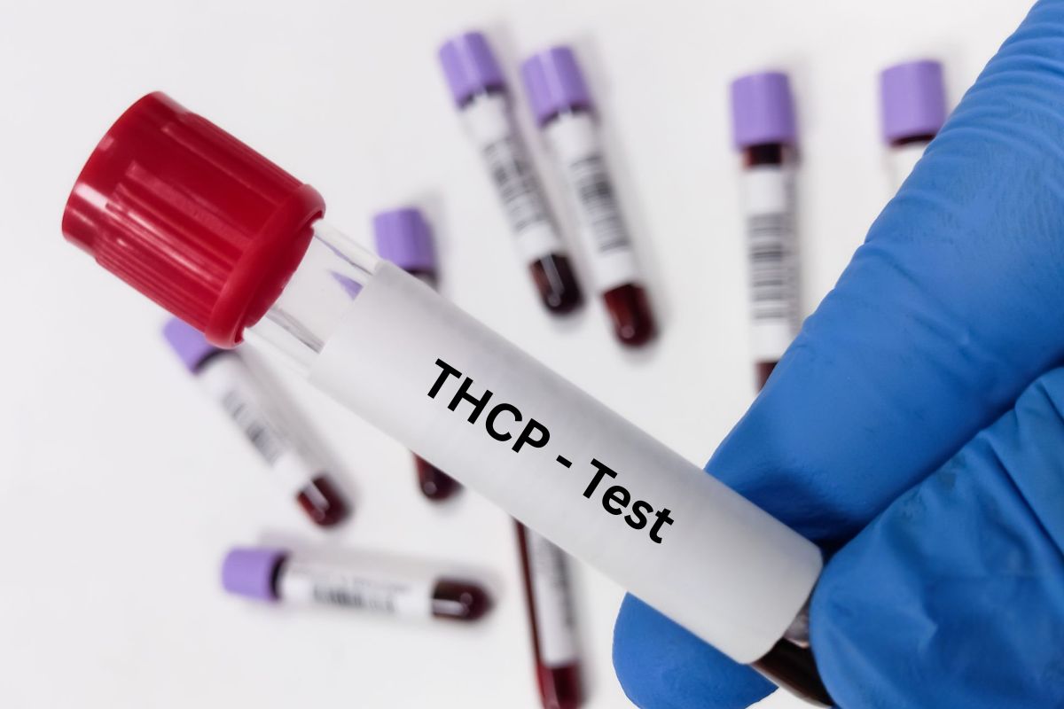 A doctor holding a blood sample for THCP and drug testing