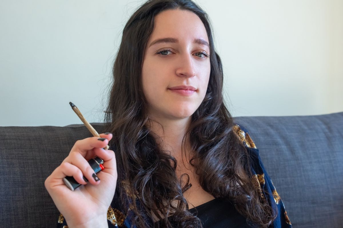 A lady smoking cannabis to get relief from mental stress