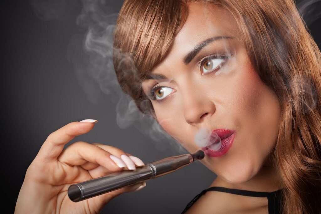 A lady vaping by the help of dab pen