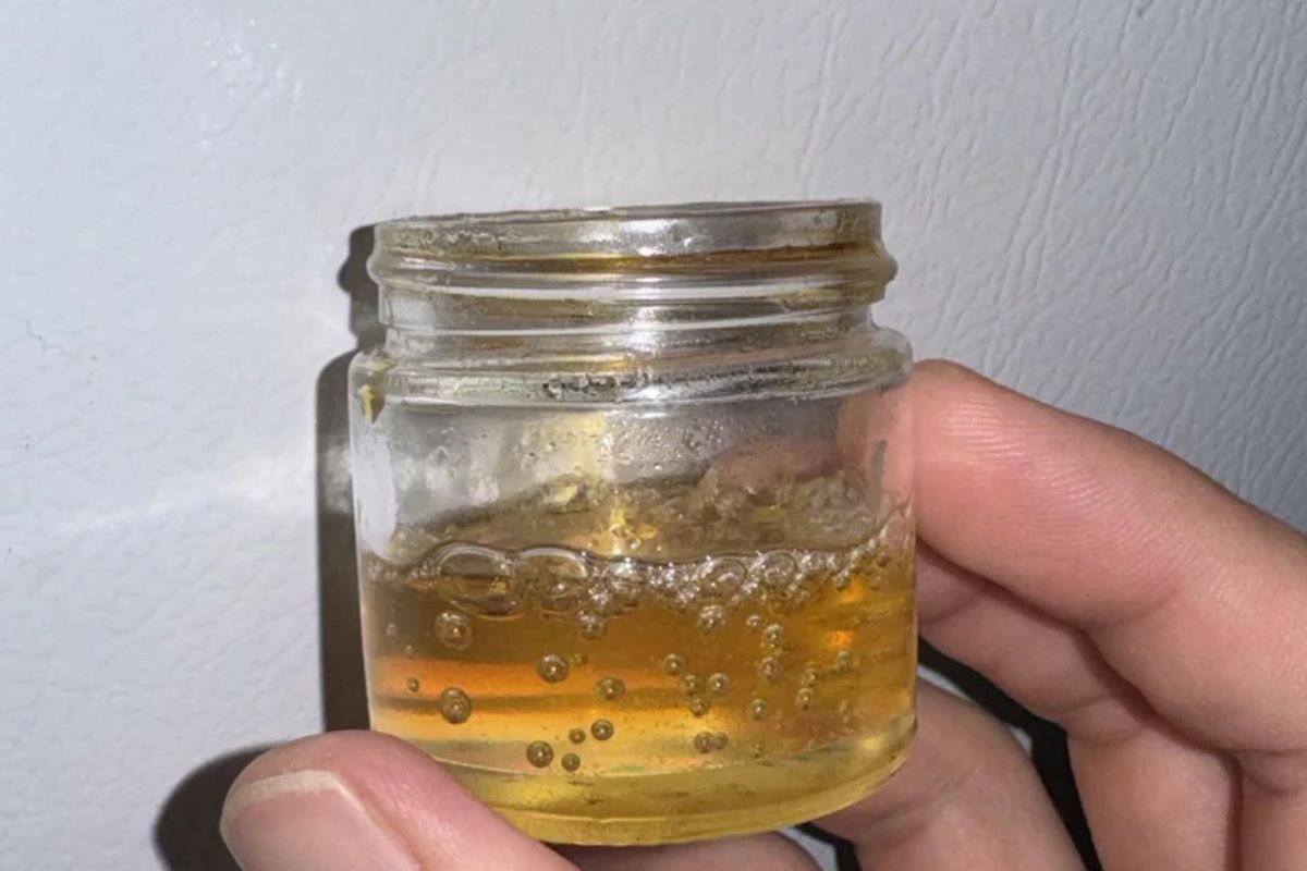 A person holding decarboxylated Wax