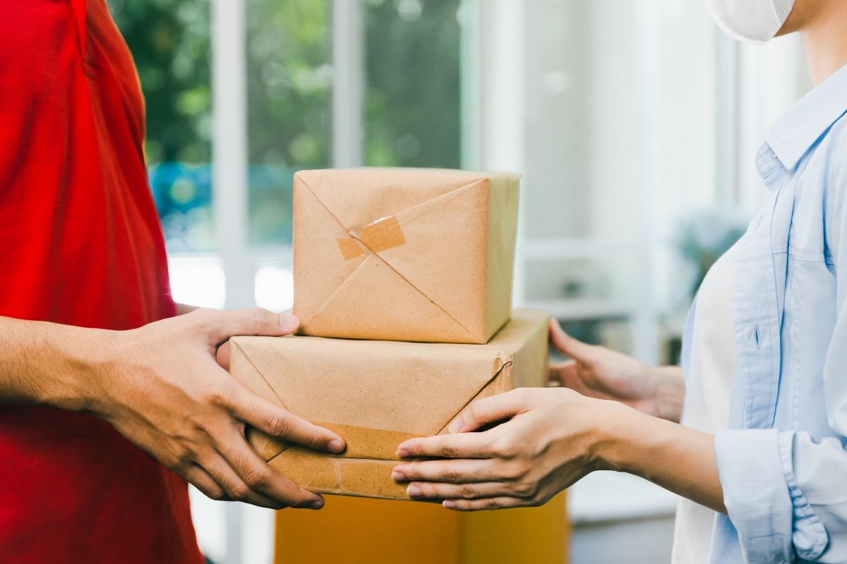 A person is delivering cannabis products to a lady who purchased them online
