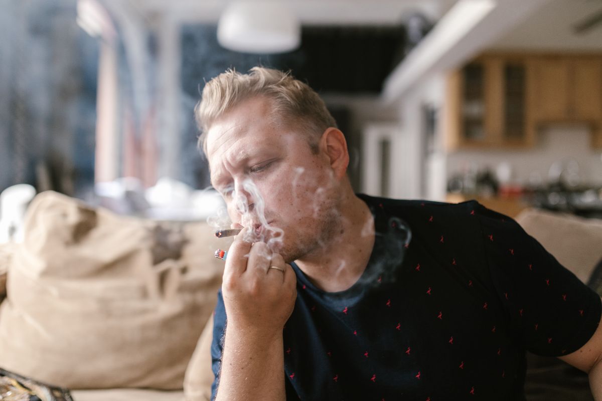 A person smoking cannabis to manage his health related problem