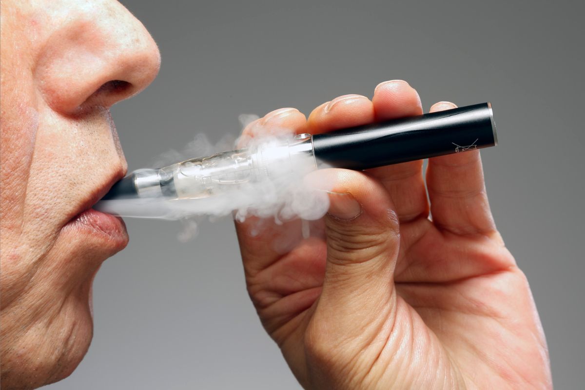 A person smoking diamond infused vape