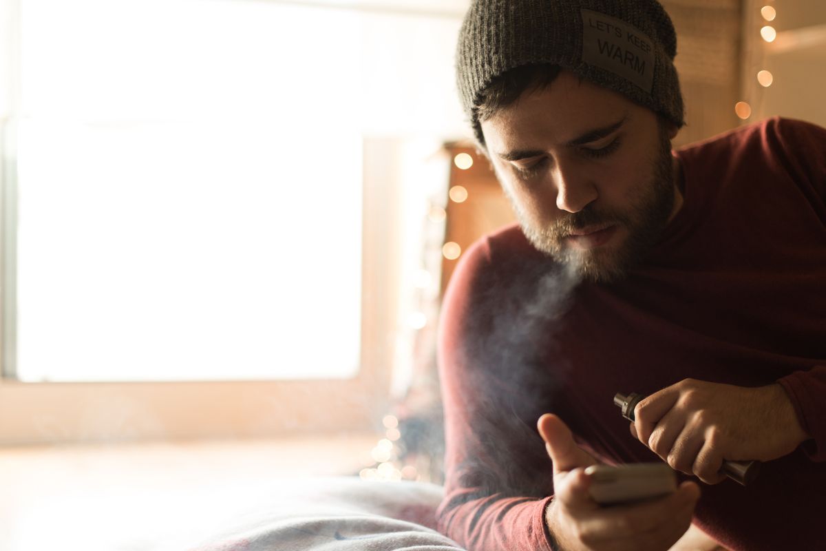 The person is vaping and producing less vapor