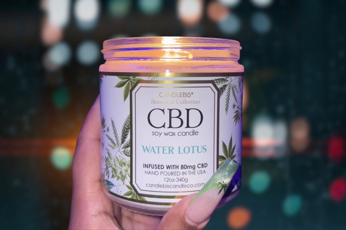 A lady holding cbd candle