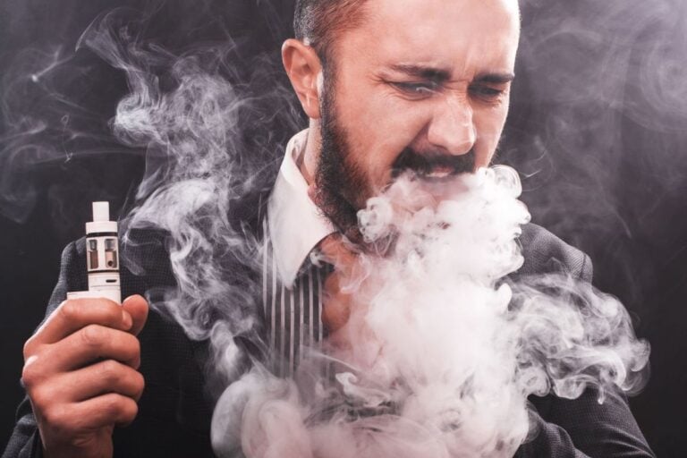 A person vaping cart and coughing
