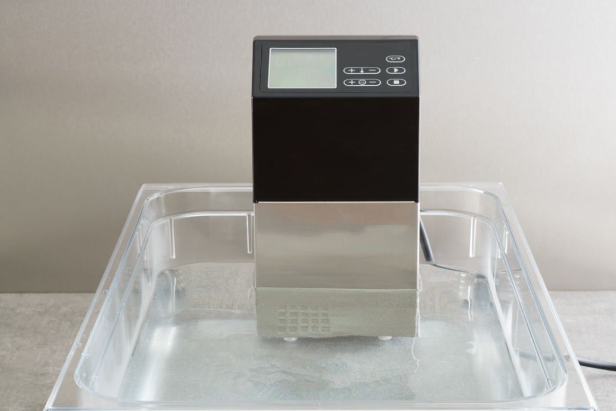 A sous vide machine with an advanced temperature control system is shown in the image