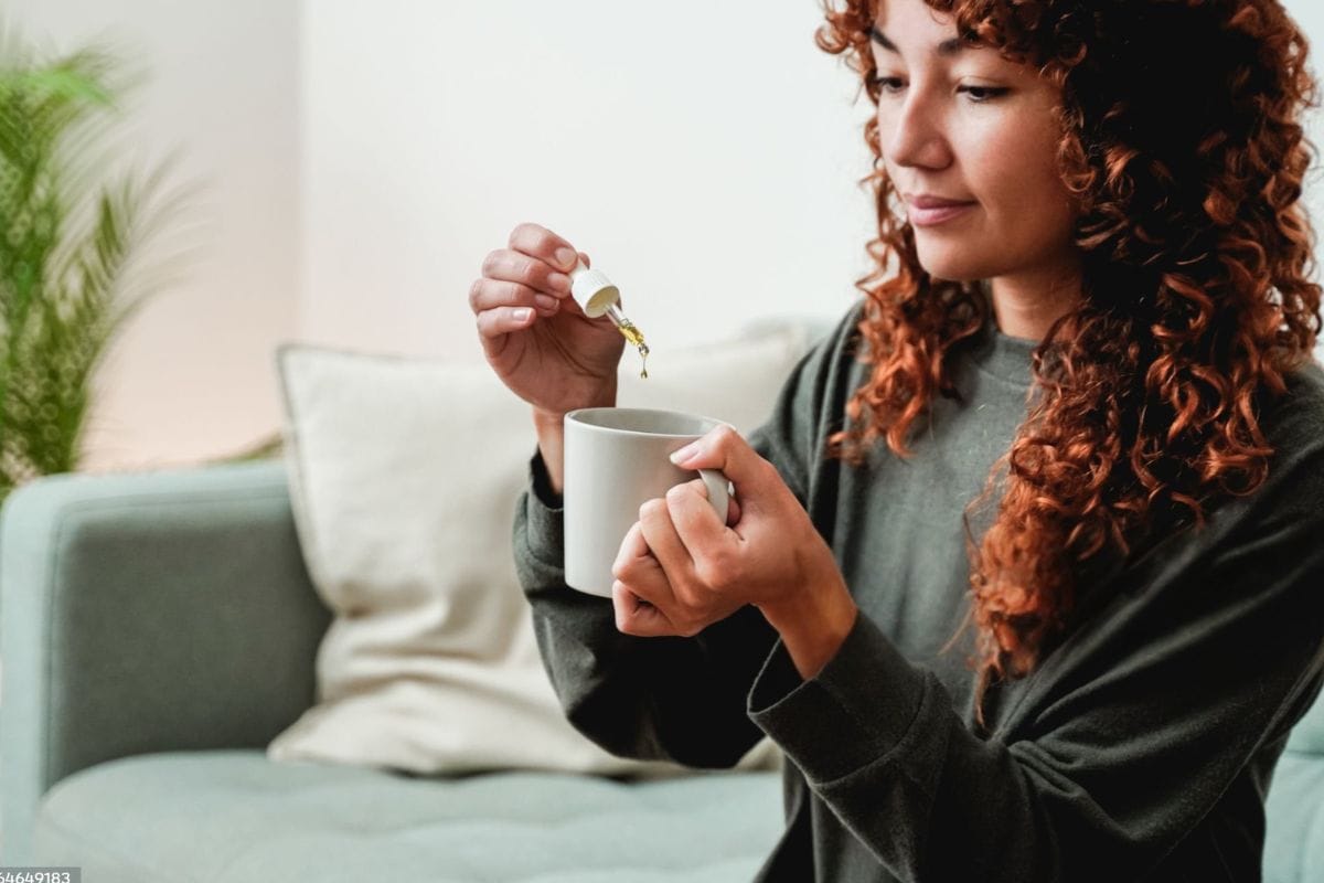 A woman microdosing with a few drops of cannabis tincture