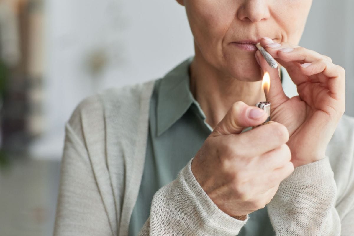 An old lady smoking thca pre-roll to get benefit from it