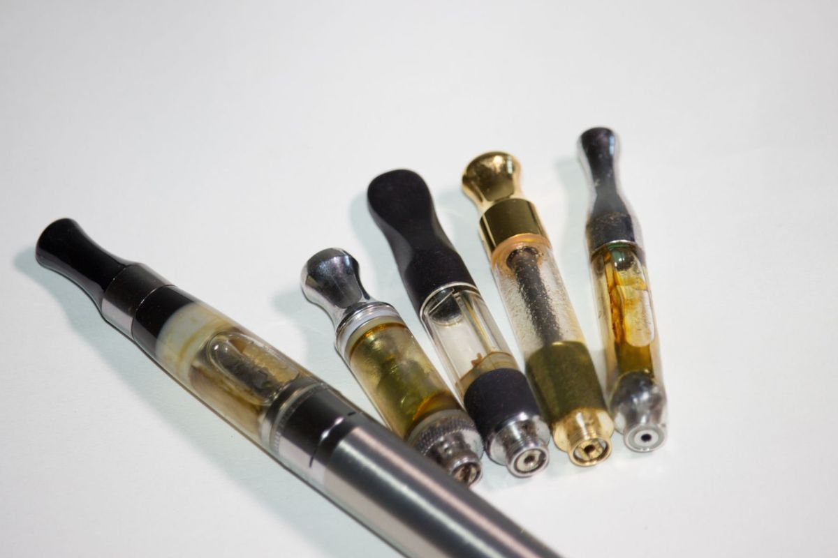 Different vape cartridge with oil stuck on the top of it