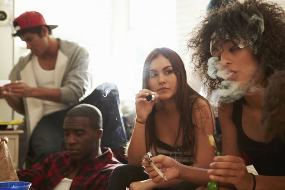 People gathered at home, using various cannabis products