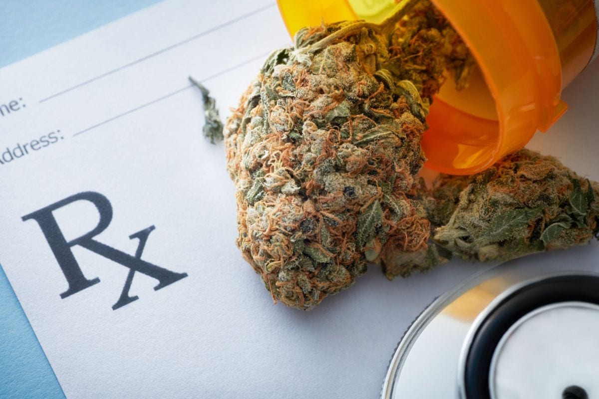 A Snow Cap cannabis flower placed next to a prescription is shown in the image