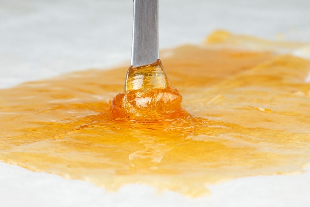 A close-up view of cannabis liquid dab is shown in the image