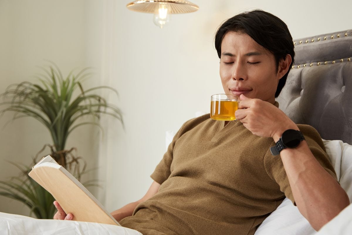 A person is drinking herbal tea to reduce the Delta-9 THC hangover