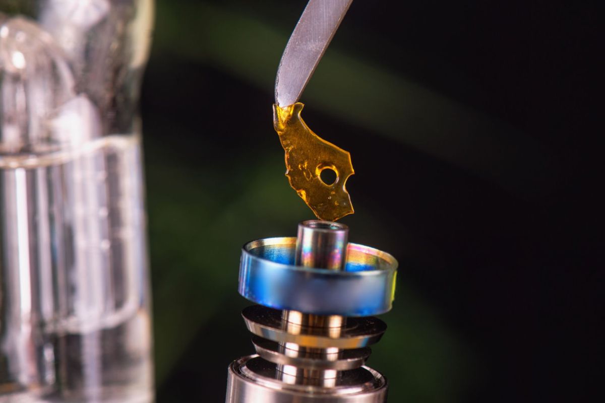A person trying to vaporize cannabis shatter