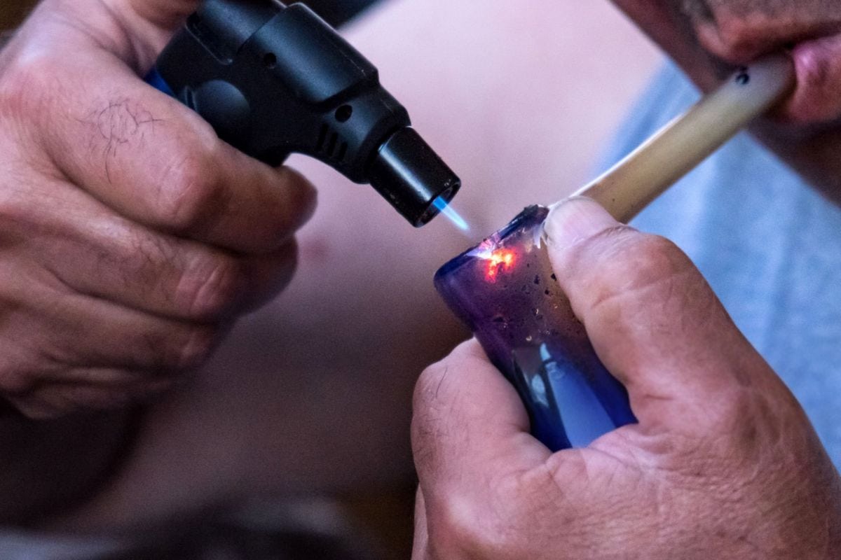 A person using a dab from a cartridge and enjoying the experience