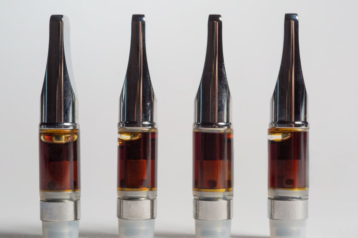 A variety of vape cartridges containing brown-colored oil
