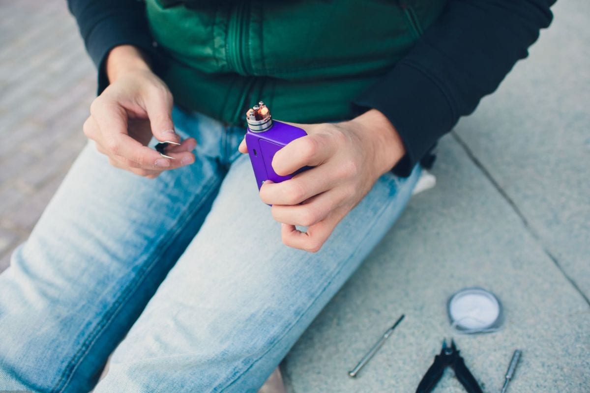 A person checking for issues in a vape pen